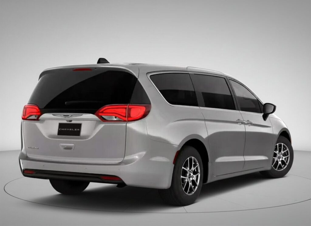 Vue arrière trois quarts d’une Chrysler Pacifica blanche dans un studio minimaliste, mettant en valeur les feux arrière DEL, les portes coulissantes et le design élégant et familial de la minifourgonnette.